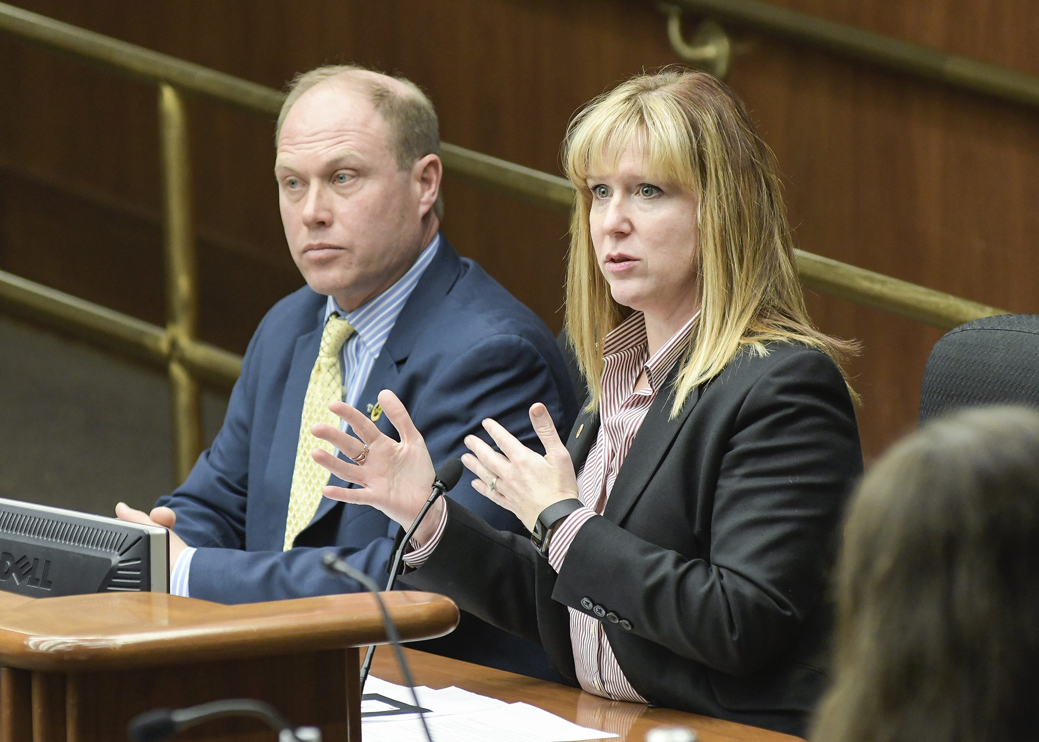 Representing Associated General Contractors, Abbey Bryduck testifies before the House Transportation and Regional Governance Policy Committee March 5 in support of a bill sponsored by Rep. Jason Rarick, left, that would authorize peace officers to issue citations based on a report from work zone flaggers.  Photo by Andrew VonBank

